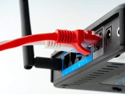 Modern router with cables plugged in close up photo